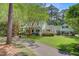Charming two-story home with lush landscaping, a long driveway, and a welcoming front porch at 107 Kimberwicke Dr, Summerville, SC 29483