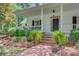 Charming front porch with brick steps, decorative plants, and classic white columns at 107 Kimberwicke Dr, Summerville, SC 29483