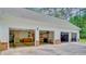 Three-car garage with visible storage and a large driveway at 107 Kimberwicke Dr, Summerville, SC 29483