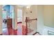 Hallway with hardwood floors, white railings, and views into other rooms at 107 Kimberwicke Dr, Summerville, SC 29483