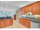 The kitchen features custom cabinets, dark countertops, tile flooring, and stainless steel appliances at 107 Kimberwicke Dr, Summerville, SC 29483