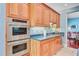 A kitchen featuring wooden cabinets, stainless steel appliances, granite countertops, and a tile floor at 107 Kimberwicke Dr, Summerville, SC 29483