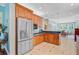 Open kitchen boasts stainless steel appliances, wood cabinetry, dark countertops, and tile flooring at 107 Kimberwicke Dr, Summerville, SC 29483