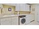 Bright laundry room with updated machines and cabinets for ample storage space at 107 Kimberwicke Dr, Summerville, SC 29483