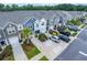 Aerial view of colorful townhomes with driveway parking, landscaping, and neighborhood street at 108 Rosefield Ct, Summerville, SC 29485