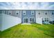 Backyard features green grass, white fence, and sliding glass doors at 108 Rosefield Ct, Summerville, SC 29485