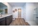 Bright bathroom with wood-look flooring, modern vanity and fixtures, plus walk-in shower at 108 Rosefield Ct, Summerville, SC 29485