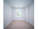 Bright bedroom with neutral carpet, a window for natural light and a minimalist aesthetic at 108 Rosefield Ct, Summerville, SC 29485