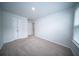 A well-lit bedroom features a window, closet, and neutral carpet at 108 Rosefield Ct, Summerville, SC 29485