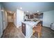 Kitchen featuring an island with seating, modern appliances, and wood-look floors at 108 Rosefield Ct, Summerville, SC 29485