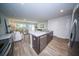 Open-concept kitchen with island, stainless steel appliances, and views to the dining and living areas at 108 Rosefield Ct, Summerville, SC 29485