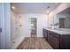 Bright bathroom with a double sink vanity, walk-in shower, and view to the main bedroom at 108 Rosefield Ct, Summerville, SC 29485