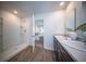 Well-lit bathroom with a double sink vanity, walk-in shower, and view to the main bedroom at 108 Rosefield Ct, Summerville, SC 29485