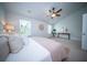 Bright main bedroom featuring a ceiling fan, large windows, and contemporary decor at 108 Rosefield Ct, Summerville, SC 29485