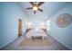 Bright main bedroom with a ceiling fan, large windows, and access to an ensuite bathroom at 108 Rosefield Ct, Summerville, SC 29485