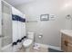 Bright bathroom featuring a shower-tub, white fixtures and framed art pieces at 1121 Basildon Rd, Mount Pleasant, SC 29466