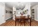 Open dining area shows wood flooring and a wood table with seating for four near the kitchen at 1121 Basildon Rd, Mount Pleasant, SC 29466