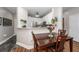 Open dining area features a wood table, a kitchen with stainless steel appliances and white cabinets at 1121 Basildon Rd, Mount Pleasant, SC 29466