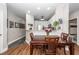 Open dining area shows wood flooring and a wood table with seating for four, with a view to the kitchen at 1121 Basildon Rd, Mount Pleasant, SC 29466