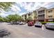 Apartment building featuring a well-maintained parking lot, yellow paint, and a private balcony for each unit at 1121 Basildon Rd, Mount Pleasant, SC 29466