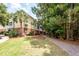 Three-story building nestled near trees and lush landscaping with a pathway at 1121 Basildon Rd, Mount Pleasant, SC 29466