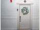 Condo front door adorned with a charming wreath and a welcome sign at 1121 Basildon Rd, Mount Pleasant, SC 29466