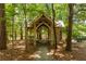 Outdoor wooden garden shed surrounded by lush trees and wood mulch at 1121 Basildon Rd, Mount Pleasant, SC 29466
