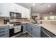 Well-lit kitchen featuring stainless steel appliances, modern tile backsplash, and gray and white cabinets at 1121 Basildon Rd, Mount Pleasant, SC 29466