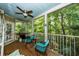Relaxing screened porch featuring comfortable seating and ceiling fan with a view of lush greenery at 1121 Basildon Rd, Mount Pleasant, SC 29466