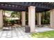 Outdoor shaded pergola features classic columns and space for games and gathering at 1121 Basildon Rd, Mount Pleasant, SC 29466