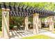 Outdoor pergola features classic columns, bench swings and a lovely shaded area at 1121 Basildon Rd, Mount Pleasant, SC 29466