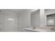 Elegant bathroom with double sink vanity, sleek fixtures and bath with white tiles at 116 Midmills Ln, Summerville, SC 29486