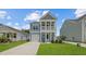A charming two-story home featuring a covered porch and well-manicured lawn at 116 Midmills Ln, Summerville, SC 29486
