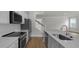 Modern kitchen featuring stainless steel appliances, white subway tile backsplash, and laminate floors at 116 Midmills Ln, Summerville, SC 29486