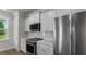 Close up of a bright kitchen featuring stainless steel appliances and white shaker style cabinets at 116 Midmills Ln, Summerville, SC 29486
