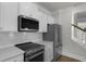 Close up of kitchen featuring stainless steel appliances, white cabinets, and a white subway tile backsplash at 116 Midmills Ln, Summerville, SC 29486