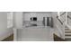 Bright kitchen with white cabinets, stainless steel appliances, quartz counters, and adjacent stairs at 116 Midmills Ln, Summerville, SC 29486