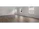 Bright living room with gray floors, white trim, and large windows overlooking the front of the house at 116 Midmills Ln, Summerville, SC 29486