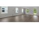 Bright living room with new gray flooring, large windows for natural light, and trim throughout at 116 Midmills Ln, Summerville, SC 29486