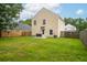 A spacious backyard with a well-maintained lawn, partial fence, and the rear of a two-story house with siding at 117 Ducane St, Summerville, SC 29483