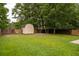 Large, grassy backyard with a storage shed and trees, providing a serene outdoor space at 117 Ducane St, Summerville, SC 29483