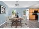 Elegant dining room with modern light fixture and adjacent kitchen at 117 Ducane St, Summerville, SC 29483