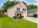 A charming two-story home featuring a well-kept lawn, and an attached garage at 117 Ducane St, Summerville, SC 29483