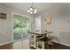 Bright dining area with a wooden table, access to the backyard, and neutral decor at 125 Crooked Creek Ct, Summerville, SC 29486