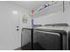Laundry room with front-loading washer and dryer and a shelf for supplies at 125 Crooked Creek Ct, Summerville, SC 29486