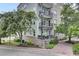 Exterior view of a condo building with charming balconies and lush landscaping at 125 Pier View St # 209, Charleston, SC 29492