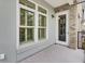 Balcony features windows, a door to interior, light fixture and concrete flooring with a partial view at 125 Pier View St # 209, Charleston, SC 29492