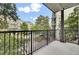 Enjoy neighborhood views from this balcony with black metal railings and partial shade from mature trees at 125 Pier View St # 209, Charleston, SC 29492