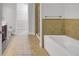 Bright bathroom with tiled floors, walk-in closet, and a separate shower with soaking tub at 125 Pier View St # 209, Charleston, SC 29492