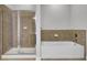 Bright bathroom with tile lined tub and walk-in shower combo with glass door at 125 Pier View St # 209, Charleston, SC 29492